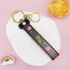 Llavero Colgante de Cordón de Cuero con Letra Transparente Brillante con Accesorios Estilo Muñeca Rellena de Aceite Encanto de Llavero Pulsera Venta al por Mayor