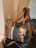 Bolsa Feminina de Comércio Exterior 2025 Nova Moda Bolsa de Lona Listrada Grande Capacidade Bolsa de Ombro Portátil para o Dia a Dia Bolsa Tote Transversal