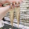 Aretes de borla super hada rojo neto cara redonda aretes delgados temperamento de Corea del Sur para mujer aretes largos de diamante de alta gama al por mayor