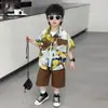 Conjunto de Camisa Floral de Estilo Vacaciones de Verano para Niños 2026 Nuevo Ropa de Dos Piezas Delgada de Manga Corta para Niños Moderna