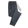 Fabricantes de origem calças casuais de verão masculinas estilo coreano plus size soltas dedo fino esportivas gelo seda stretch calças retas