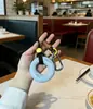 Colgantes para entrenador de fuerza de agarre al por mayor, anillos de agarre, llaveros para aliviar el estrés, dijes para bolsas de pareja, cadenas para coche, regalos creativos de fitness
