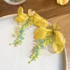 Flor de chifre com agulha de prata Flor com contas Laço de flor Brincos com borla redonda Brincos de tarraxa versáteis e elegantes Brincos de nicho de luxo leve