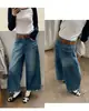 Otoño TOP estilo europeo Guangzhou Trece Líneas jeans acampanados de 8 puntos con lavado deshilachado distintivo en forma de V con cinturón 61856