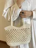 Bolsa de playa portátil de gran capacidad para mujer, nuevo diseño de primavera 2026, bolsa tejida hueca, bolso casual versátil para hombro y axila