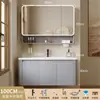 Tocador de baño engrosado y ahorrador de espacio con diseño en color crema, que cuenta con un lavabo redondeado, lavabo cerámico integrado y un lavabo de una sola pieza.