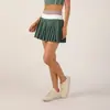 Conjunto deportivo de dos piezas para mujer, chaleco deportivo de retazos tricolor transfronterizo con falda de tenis plisada de cintura alta anti-exposición, para fitness al aire libre y correr