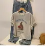 Camiseta Redonda Manga Curta Estampa de Desenho Animado Retro Americana Design de Verão 2026 Novo Estilo Blusa Solta de Meia-Manga