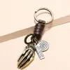 Joyas de Moda Transfronterizas de Alta Venta Colgante Creativo de Aleación Hueso de Mano Llavero Decorativo Accesorio Trenzado de Cuero Estilo Retro