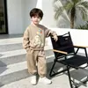 Nuevo conjunto de ropa infantil estilo coreano para primavera y otoño 2026, moderno conjunto de sudadera para niños y niñas, ropa infantil de dos piezas para primavera