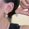 Pendientes de lazo con microincrustaciones de lujo ligeros para mujer, elegantes y a la moda, combinables con todo, de estilo socialité, con piedra de ojo de gato, al por mayor