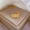 [Ouro Real] Anel de torção cruzada coreana abertura pulseira simples ajustável anel japonês anel casal