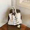 Nova Bolsa de Ombro Casual de Grande Capacidade para Mulheres 2026, Bolsa Tote com Design de Nicho Estilo Coreano, Bolsa de Tecido para Trabalho e Deslocamento