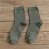 Otoño e invierno nuevos calcetines para hombre y mujer Tubo clásico para jalar Amantes Joker color sólido algodón calcetines para hombre al por mayor