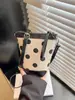 Bolso cubo de moda de lunares transfronterizo, bolso de hombro versátil y elegante estilo coreano para el uso diario y el trabajo, bolso cruzado de color block de nicho