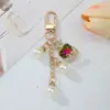 Moda Europeia e Americana Imitação de Pérola e Strass Pingente de Chaveiro de Frasco de Perfume Versátil Exquisito Acessório para Corrente de Celular de Menina