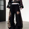 Calça de moletom casual larga e estilosa estilo americano com grafite de espinhos e estampas grandes em ambos os lados, calça de dança casual hip-hop