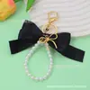 Lindo Llavero con Cadena de Perlas y Lazo de Cinta de Satén Colgante de Lazo Metálico Decoración para Bolso Venta Caliente Transfronteriza