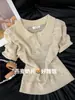 Top de punto de manga corta calado de ganchillo con cuello polo de seda helada color avena para mujer, nuevo y versátil para el verano 2026