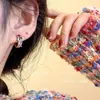 Pendientes de circonita coloridos pendientes pequeños exquisitos 2023 nuevos pendientes de anillo estilo occidental femenino alto sentido
