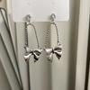 Pendientes de lazo de metal plateado con diamantes de imitación de estilo frío, nuevos y modernos pendientes de diseño de nicho de alta gama, elegantes y elegantes.
