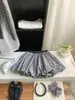 Falda de Cuadros Retro con Botones para Persona Pequeña Falda Media para Mujer Verano 2026 Versátil Anti-Exposición Falda Corta de Corte A Serie Blanco y Negro Esponjosa