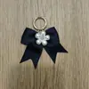 Lazo Negro de Satén Tejido a Mano Anillo de Resorte Metálico Broche Colgante Decorativo para Bolsos y Zapatos DIY