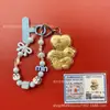 Llavero de tela con logo de empresa personalizado Cadena para teléfono móvil Angela Lámina de oro puro Oro 999 Regalo de aniversario