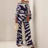 Moda femenina transfronteriza europea y americana 2026: conjunto de dos piezas: top estampado de un solo hombro, holgado y moderno, combinado con pantalones de pierna ancha