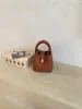 Bolso cubo texturizado de comercio exterior transfronterizo para mujer, 26 modelos nuevos, bolso de mano de alta estética casual, bolso versátil de hombro y cruzado