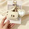 Nueva funda de espejo para auriculares de color sólido en forma de corazón, mini monedero simple, llavero portátil, accesorio de bolso de alta gama