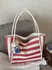 Bolso de mano tejido a rayas de moda transfronterizo 2026 nuevo versátil para el trabajo bolsa grande estilo coreano de gran capacidad para mujer