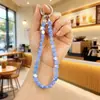 Nuevo Colgante de Cristal Super Brillante Acrílico Bolsa Auriculares Bluetooth Colgante Pequeño Llavero de Coche Cadena para Teléfono Móvil Venta al por Mayor
