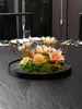 Mesa redonda grande en el centro colocada flores flores estilo chino flores artificiales decoraciones adornos de micro paisajismo significado Zen sala privada plato redondo mesa de comedor flores