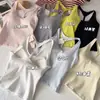 Camiseta sin mangas de tirantes con espalda descubierta, estilo nuevo de verano 2026 para mujer, con copas de sujetador incorporadas, adecuada para usar en capas o sola, top corto