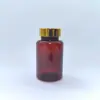 Directo del FabricanteBotella de PET marrón para productos de salud con tapa dorada, botella para cápsulas, botella de plástico para productos de salud disponible