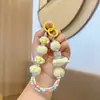 Cadena colgante para teléfono móvil con cuentas de bola de pelo al por mayor, avión, dibujos animados pintados a mano, llavero para bolso, llavero de pulsador, pequeño regalo