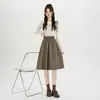Nueva falda de otoño e invierno de cintura alta en línea A, elegante falda de cuero, falda negra versátil de longitud media
