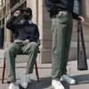 Pantalones casuales funcionales populares de otoño, nuevos, para trabajo al aire libre, con etiqueta blanca pequeña, corte holgado, versátiles, estilo de moda de alta costura para hombres y mujeres, adecuados para parejas