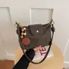 Bolso de axila de estilo francés de nicho transfronterizo para mujer, nuevo bolso de moda tipo albóndiga de gamuza para el trabajo, bolso de hombro y cruzado casual