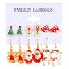 Pendientes navideños europeos y americanos con combinación de aleación, muñeco de nieve, copo de nieve, alce y árbol de Navidad.
