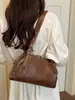 Bolsa de ombro Boston vintage desgastada de outono para mulheres, nova bolsa de ombro e transversal tipo travesseiro de couro macio de nicho 2026