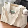 Bolsa de lona tipo tote personalizada de gran capacidad para el trabajo, los desplazamientos diarios y el uso cotidiano; un bolso de hombro elegante para estudiantes, con 12 compartimentos y múltiples bolsillos