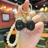 Chaveiro de corrente de pérolas com laço de strass fofo, best-seller internacional, pingente de decoração para bolsa feminina da moda coreana