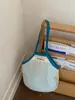 Bolsa de Palha Tecida de Luxo para Verão 2025 Nova Moda Vazada Versátil Grande Capacidade Ombro Bolsa de Axila