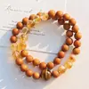 Pulsera con Diseño Multicírculo de Sándalo Natural, Cristal Amarillo y Ojo de Tigre