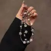 2026 Nuevos Exquisitos Dulces y Frescos Accesorios Cadena para Teléfono con Cuentas de Cristal Colgante de Borla de Flor Adorno de Moda