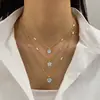 Collar Clavícula Retro Francés de Imitación Perla con Borla de Corazón de Tres Capas Apilable Europeo y Americano Nicho Temperamento de Gama Alta para Mujeres