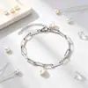 Nuevo brazalete de clip de papel de perla personalizado transfronterizo europeo y americano, diseño de nicho, joyería de acero inoxidable chapado en oro, disponible para venta al por mayor