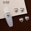 Nuevos accesorios de aleación para decoración de uñas con forma de corazón torcido tridimensional liso con diseño de amor hueco retro japonés
